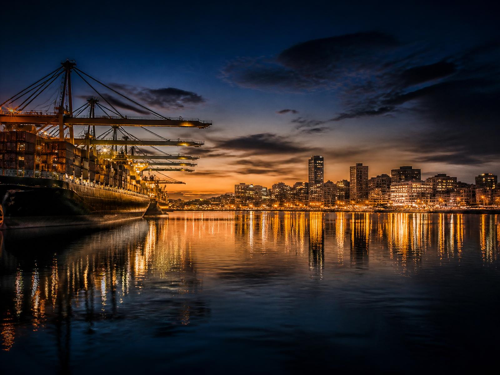Durban Harbour at dusk with city lights reflecting on the water